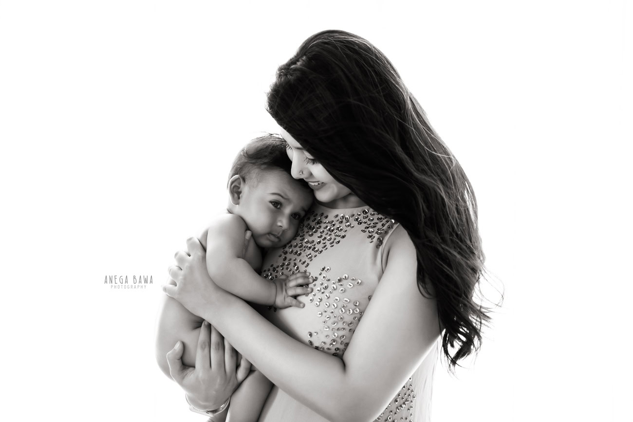Family photoshoot with a mom-son duo against a white backdrop in Delhi and Gurgaon, photographed by Anega Bawa Photography.
