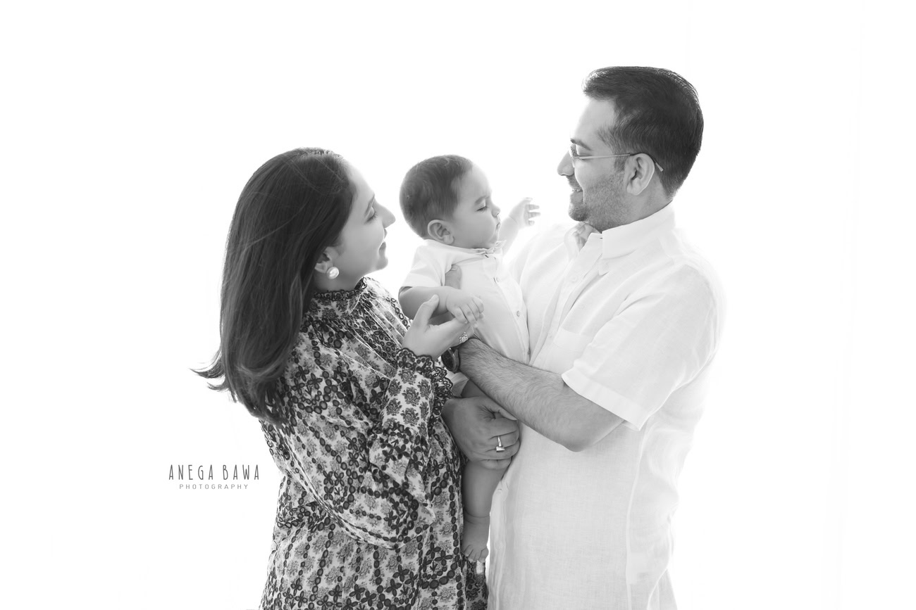 Create everlasting memories with Anega Bawa Photography in Delhi and Gurgaon. Let Mumma, Papa, and their little boy shine against a pristine white backdrop, capturing the essence of family love and togetherness.