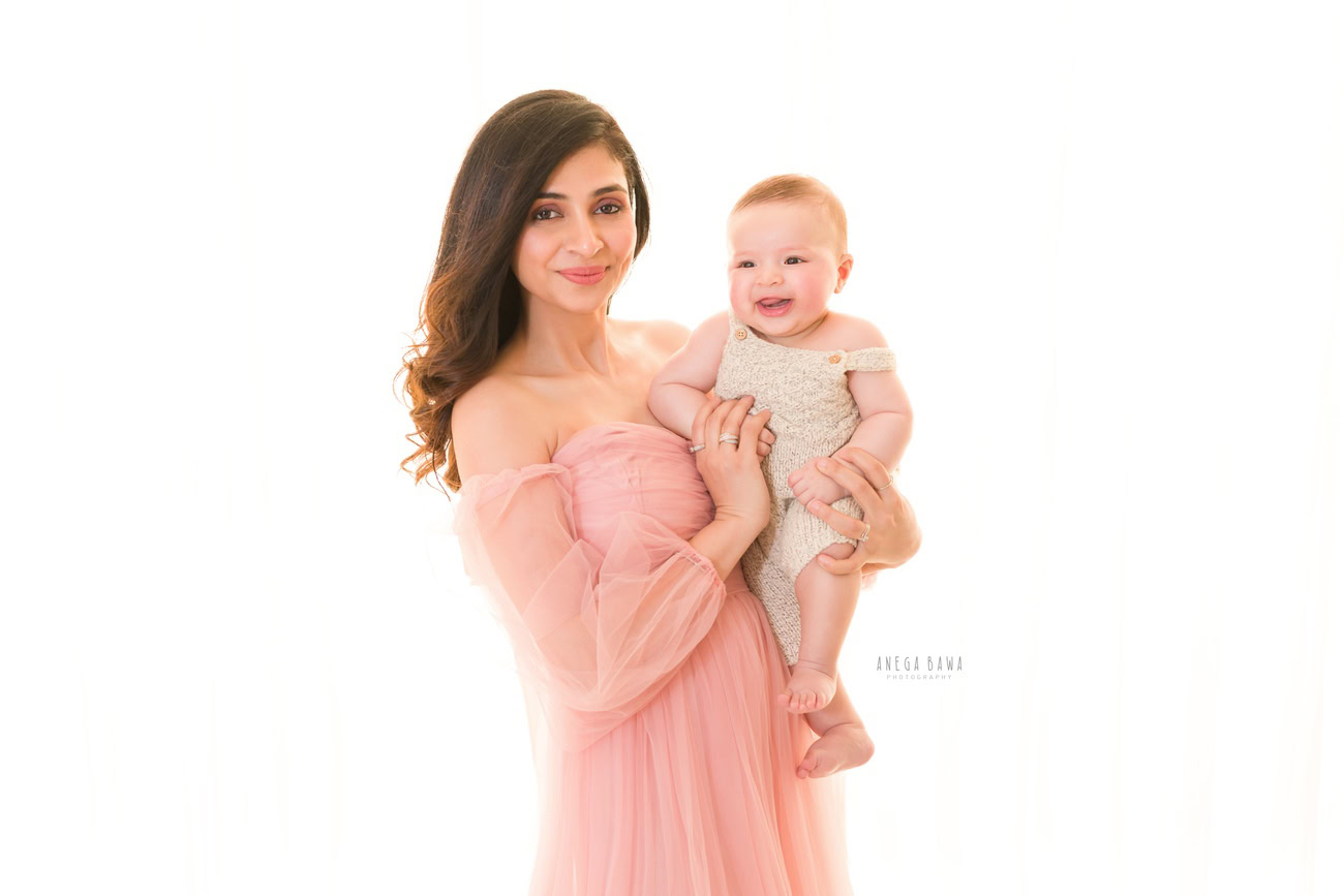 Embrace the love and joy of family moments with Anega Bawa Photography in Delhi and Gurgaon. Mumma dons a stunning peach gown while sharing a heartwarming smile with her adorable son, creating a timeless and precious memory to cherish forever.