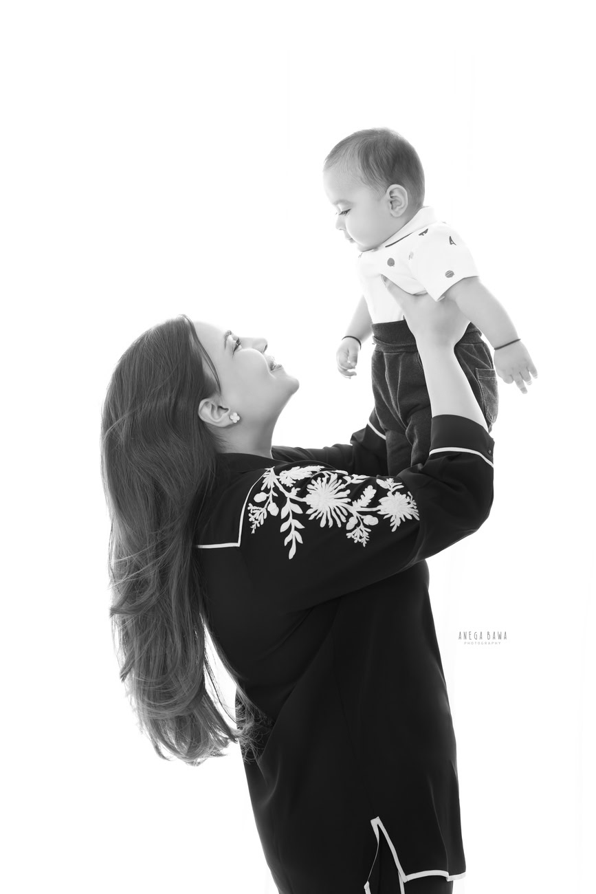 Create cherished moments with Anega Bawa Photography in Delhi and Gurgaon as Mumma engages in playful moments with her son against a captivating white backdrop. Let the joy and laughter of your family radiate through each frame, capturing the beauty of these precious bonds.