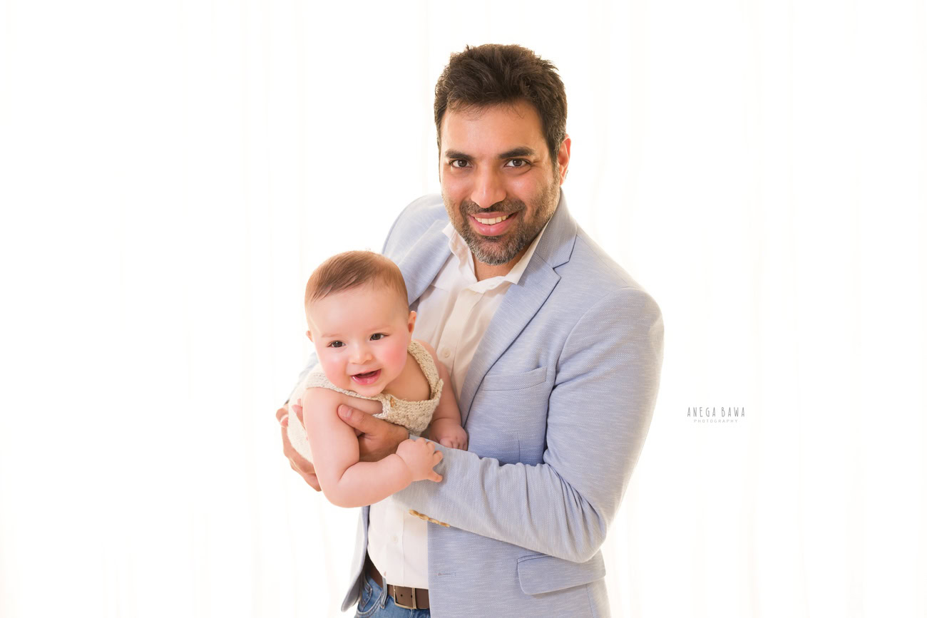 Capture the precious moments of Papa holding his son against a clean white backdrop with Anega Bawa Photography in Delhi and Gurgaon. Let the love and connection between father and son shine through in every frame.