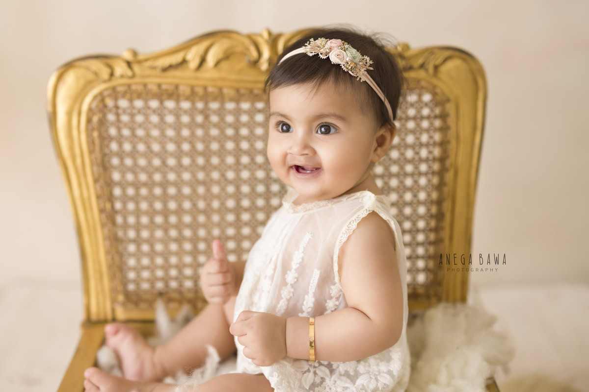 Captured by Anega Bawa in Gurgaon, this endearing photograph showcases a 14-month-old girl sitting on a golden chair against a beige backdrop. With a sense of poise and innocence, she engages the viewer with her captivating presence. Anega Bawa's skillful photography captures the essence of the moment, preserving this precious stage of childhood for years to come.