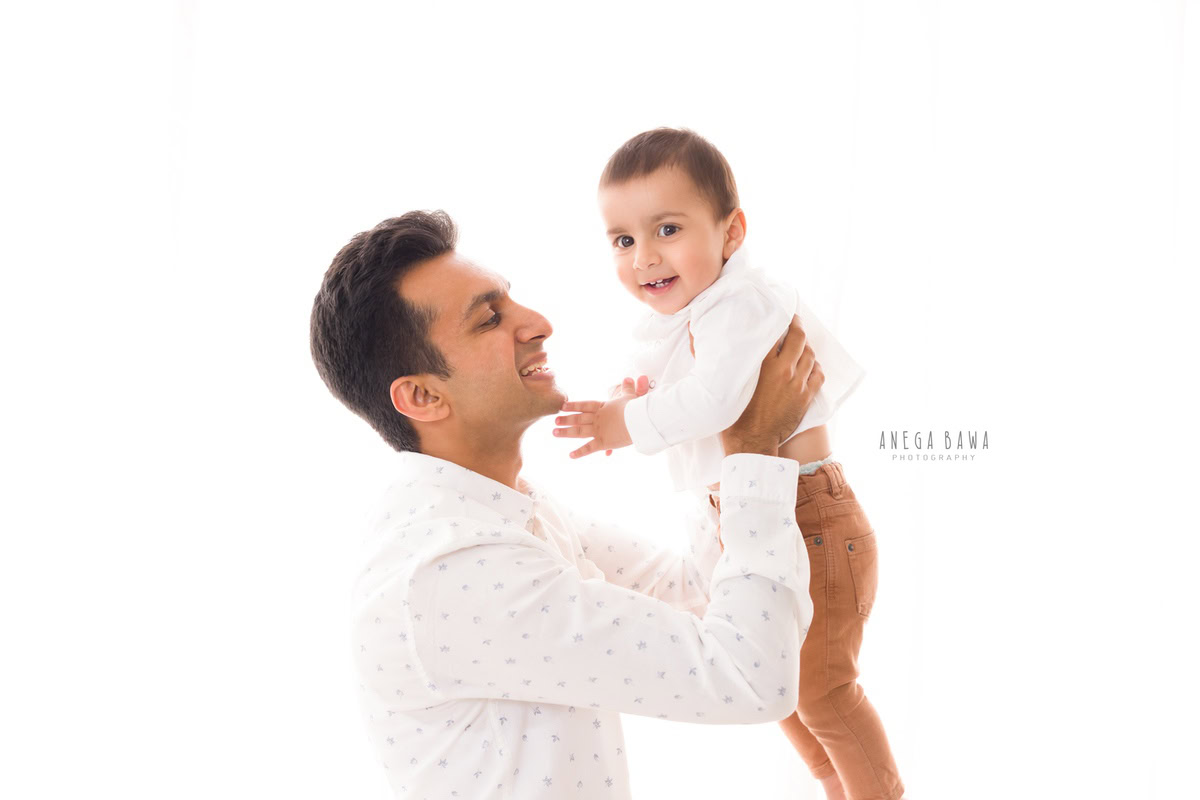 1-year boy lifted in dad's arms captured beautifully by Anega Bawa Photography, your expert for family photo shoots in Gurgaon (Delhi NCR).