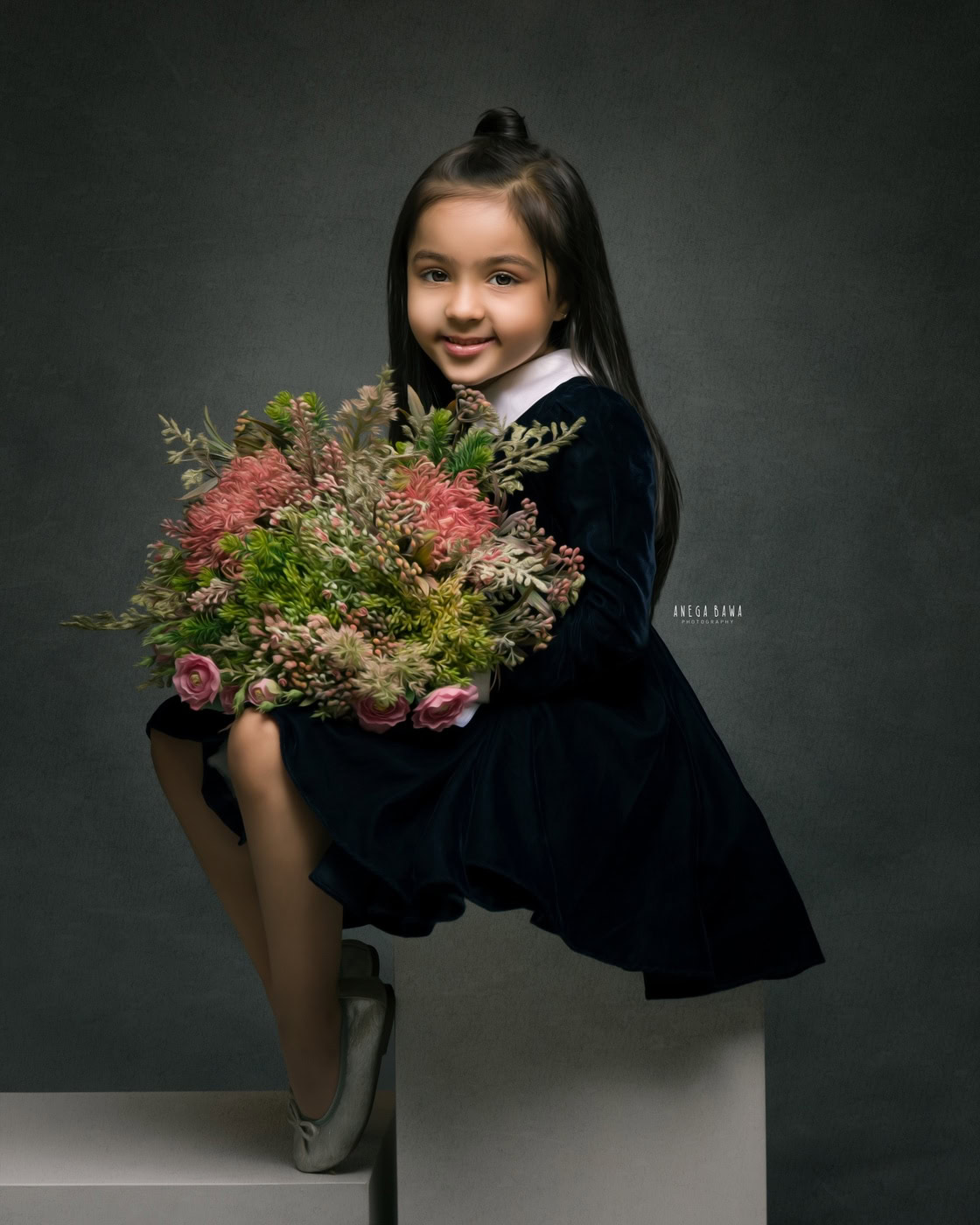 3 year girl sitting on a stool holding a bouquet against a grey backdrop in a black-and-white family photography session by Anega Bawa in Delhi, Gurgaon. The classic tones enhance her charm and the elegance of the moment.