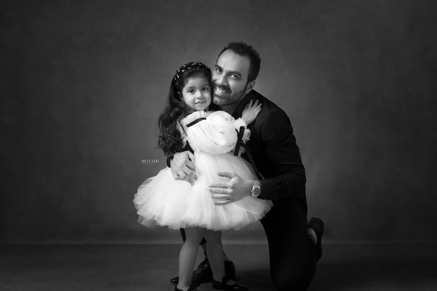 Beautiful black and white portrait of a father and daughter, capturing a heartfelt moment with professional photography by Anega Bawa.