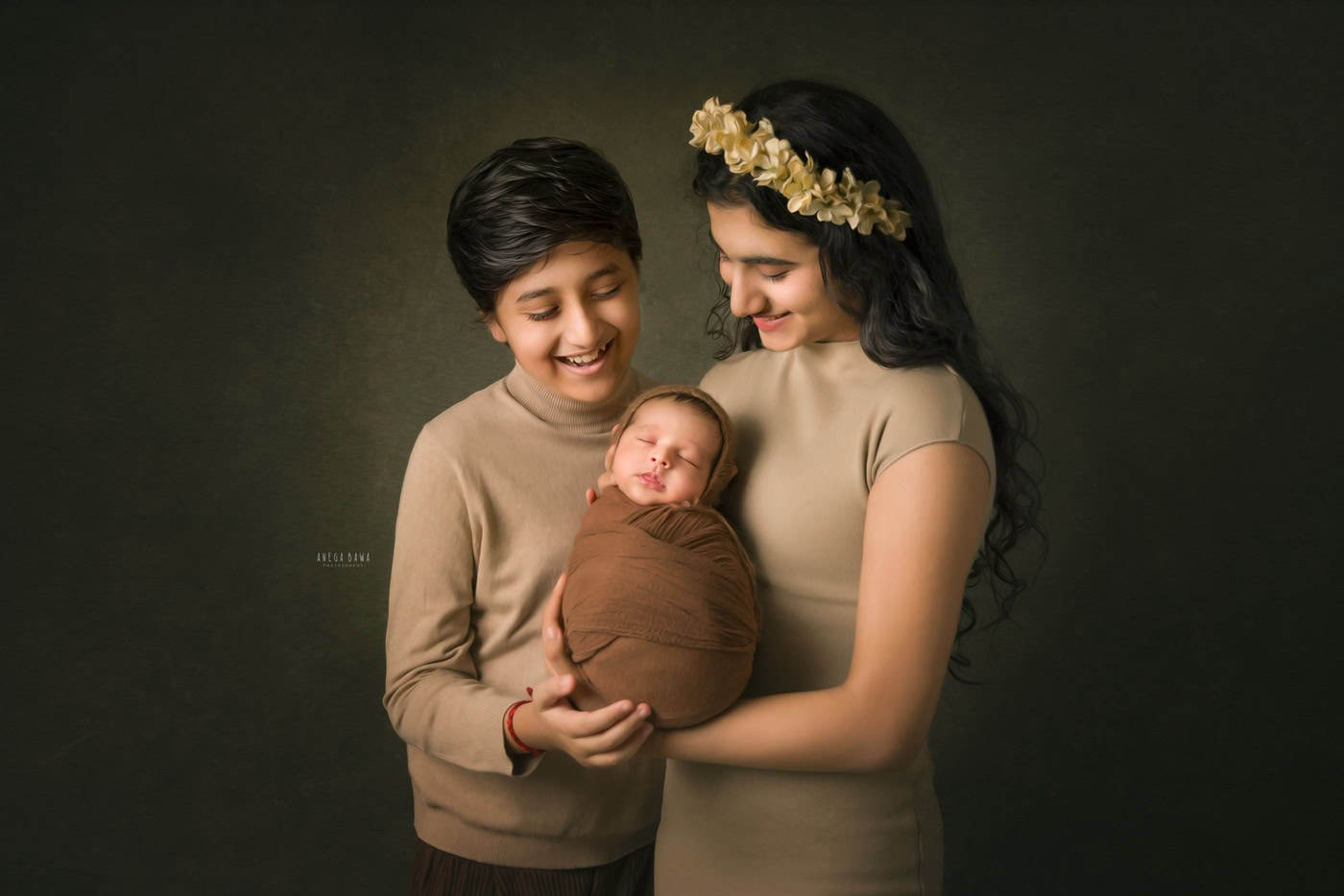 Soft-focused portrait of a happy family with a newborn baby, mother and older sibling holding and admiring the infant, professional newborn photography, warm tones, Anega Bawa Photography.