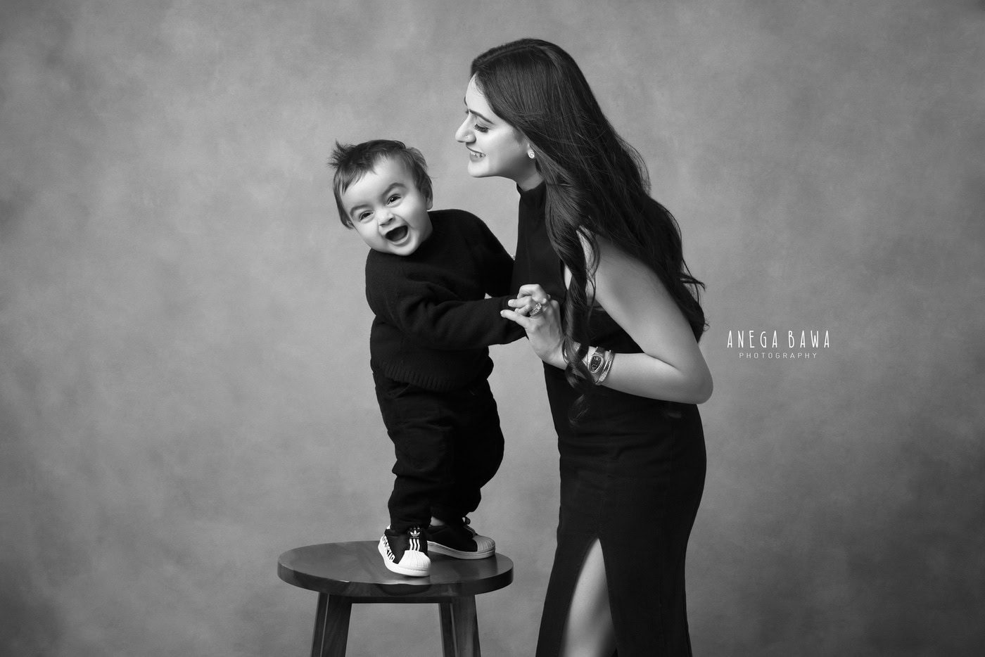Happy mother and son laughing together in a black and white photography portrait; professional family photography by Anega Bawa Photography.