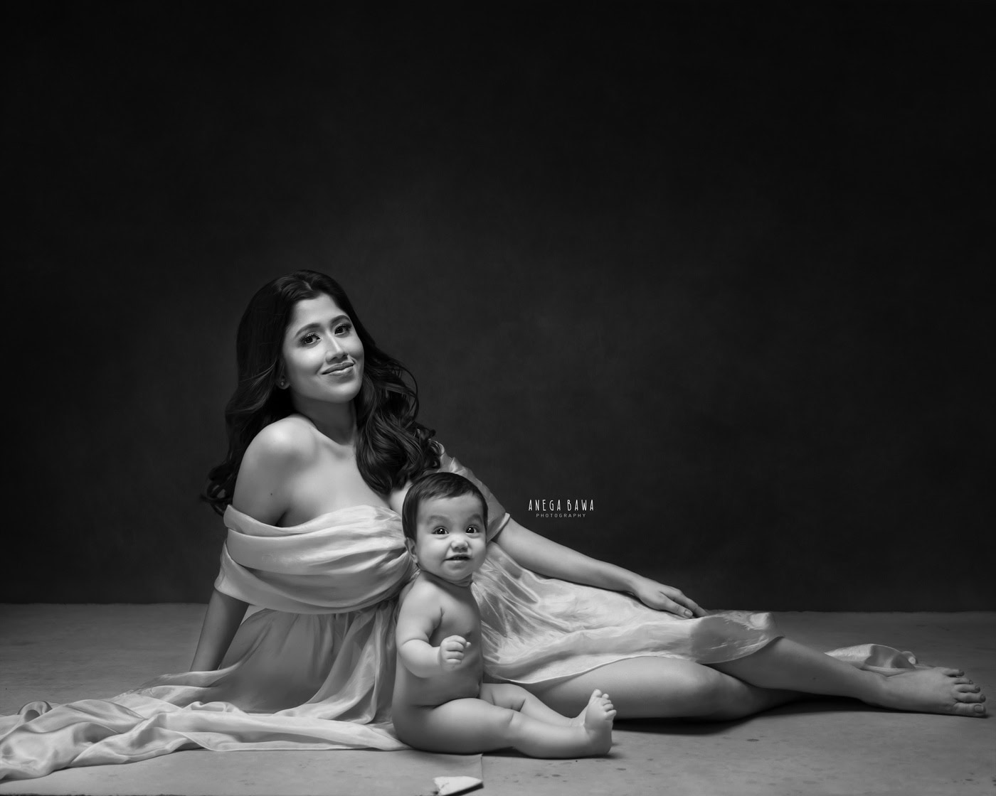 Elegant mother and baby portrait in monochrome, showcasing fine art maternity and family photography by Anega Bawa.