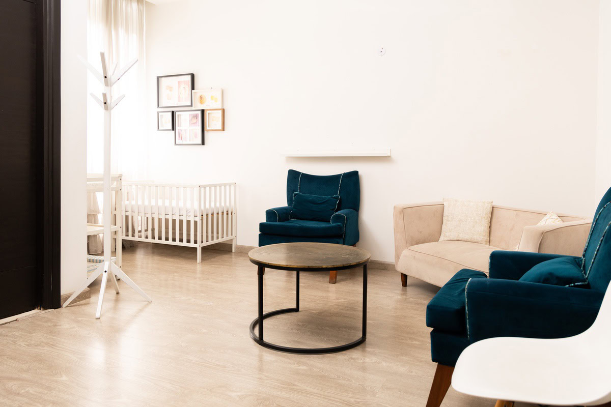 Minimalist living room with cozy velvet armchairs, beige sofa, and modern decor, perfect for interior photography and home staging.